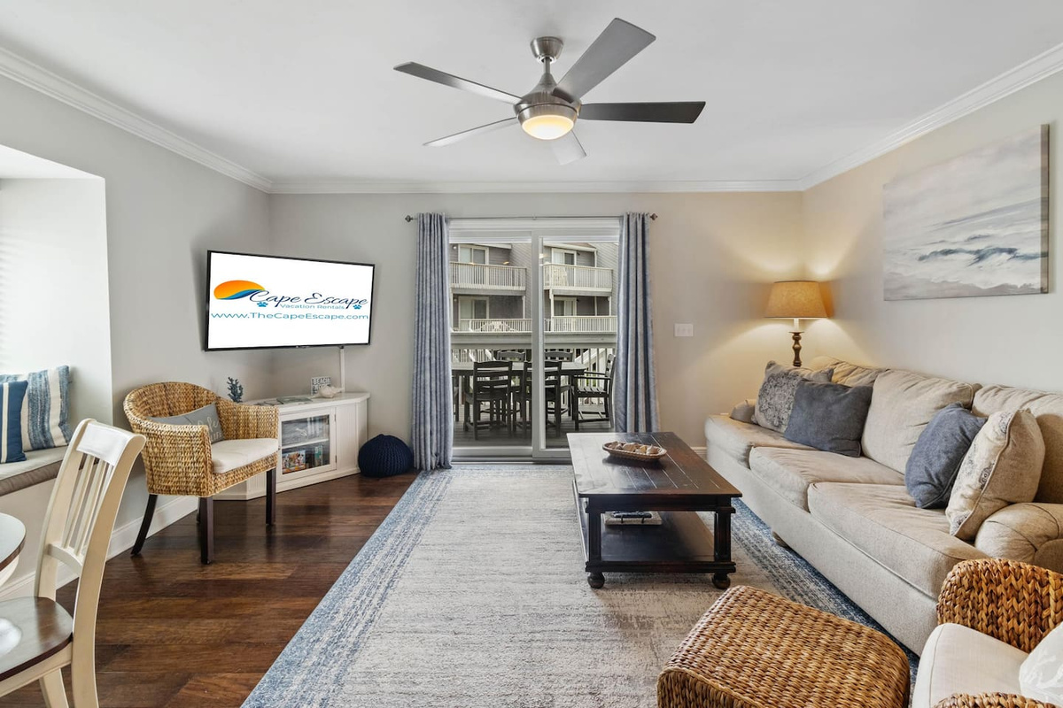 Open the sliding doors and step onto the deck &mdash; beach air, Gulf light, and the living room all blending together on a perfect day.
