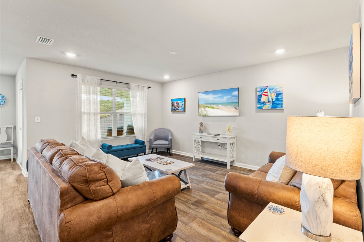 Cozy living room with plush seating and beach-inspired decor, perfect for family movie nights or morning coffee.