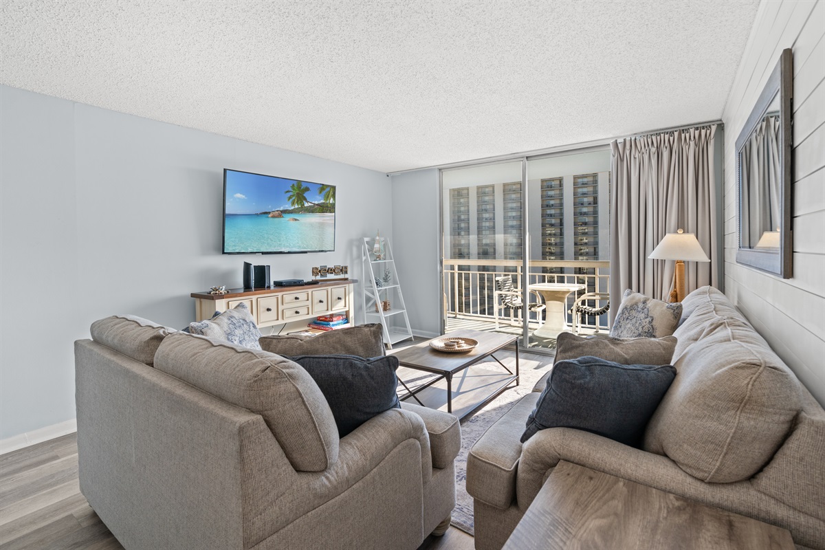 Large Living Room with plenty of seating, balcony access and large screen TV