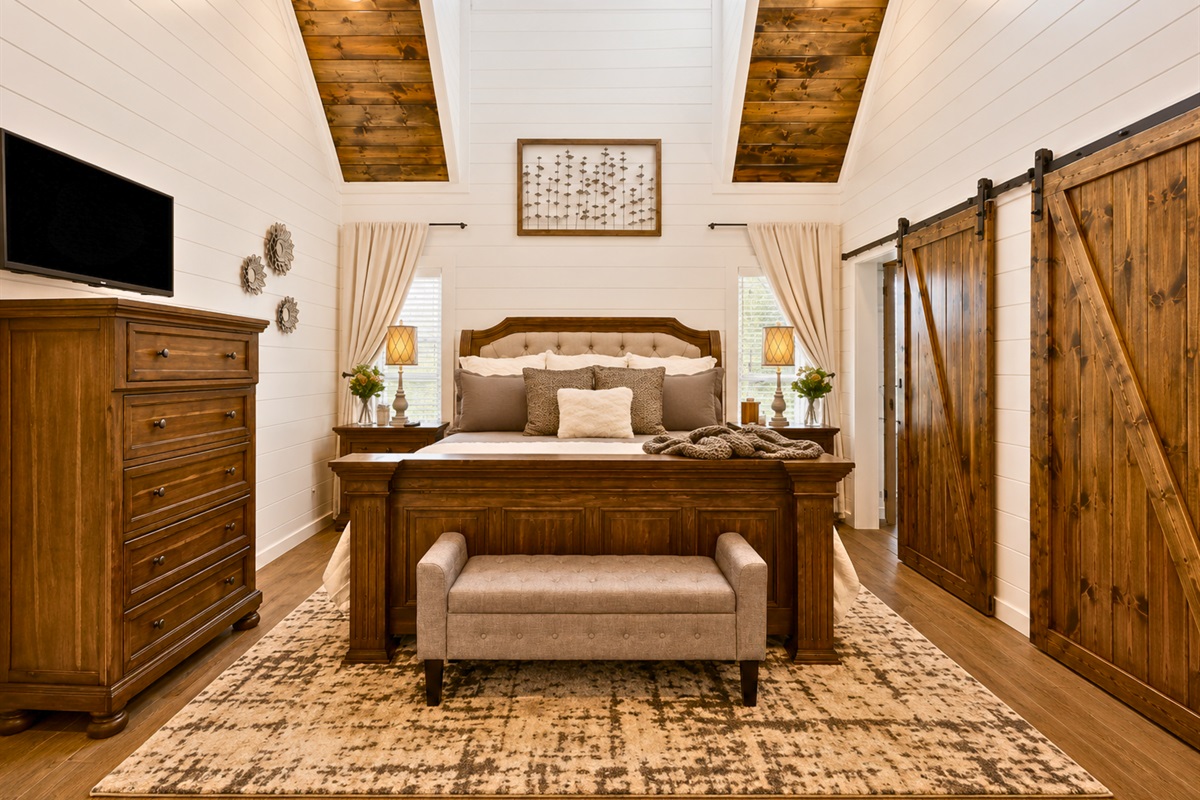Relax in the plush king bed after a day exploring Broken Bow while enjoying the cozy cabin feel throughout the suite.