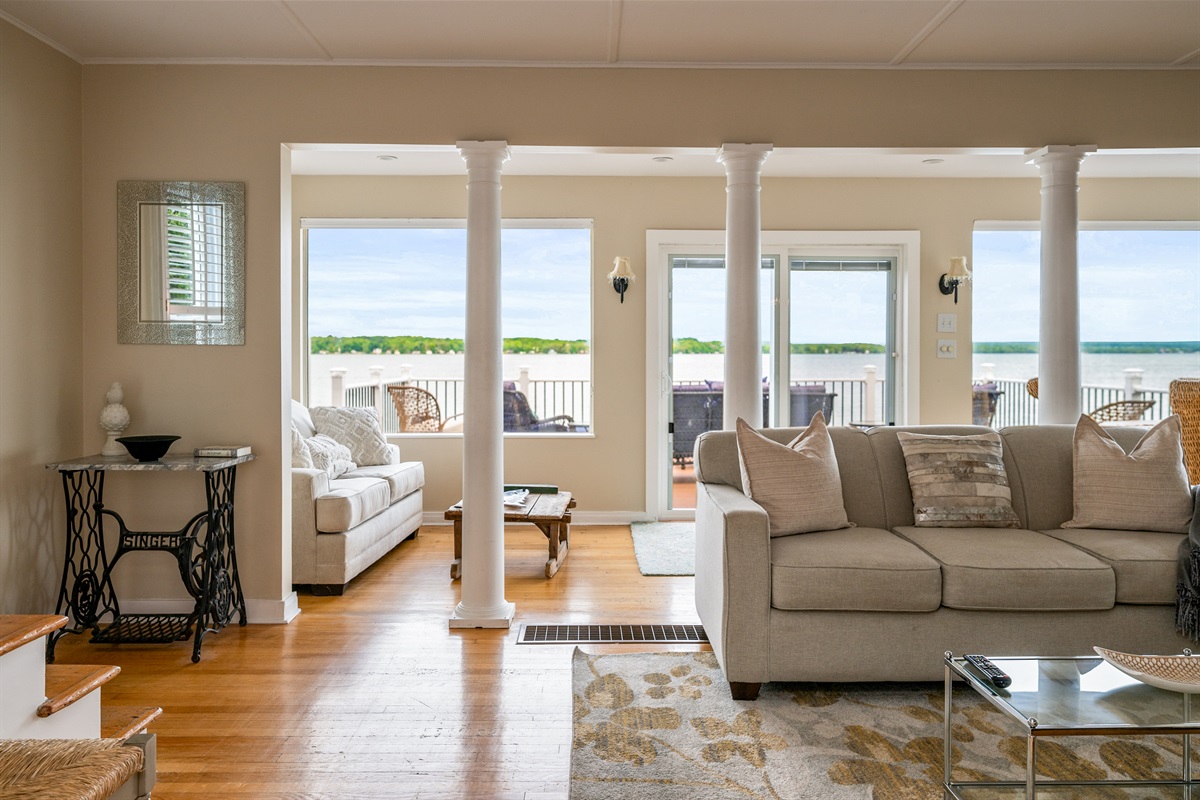 Bright and airy living space with panoramic lake views and direct access to the waterfront deck 🌊🛋️☀️