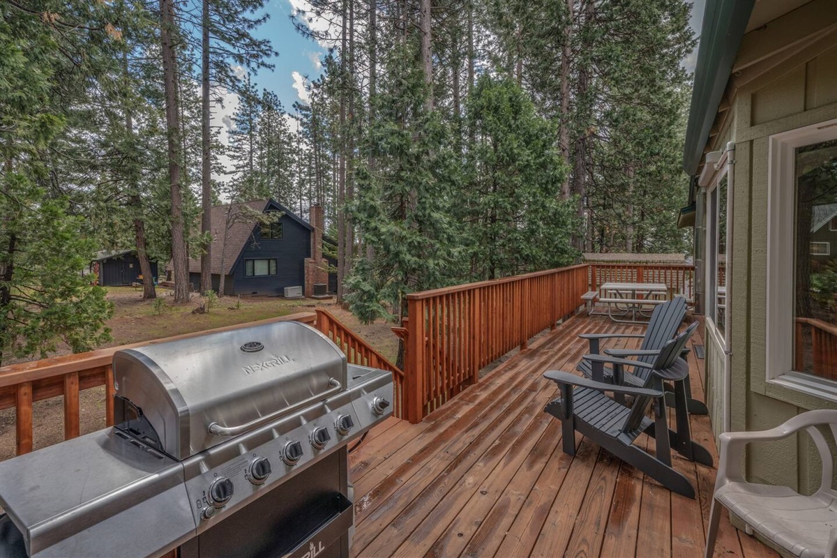 Back Deck with beautiful view of open yard. Outdoor table with seating for 8. Plenty of room for the little ones to run around or play in the snow.