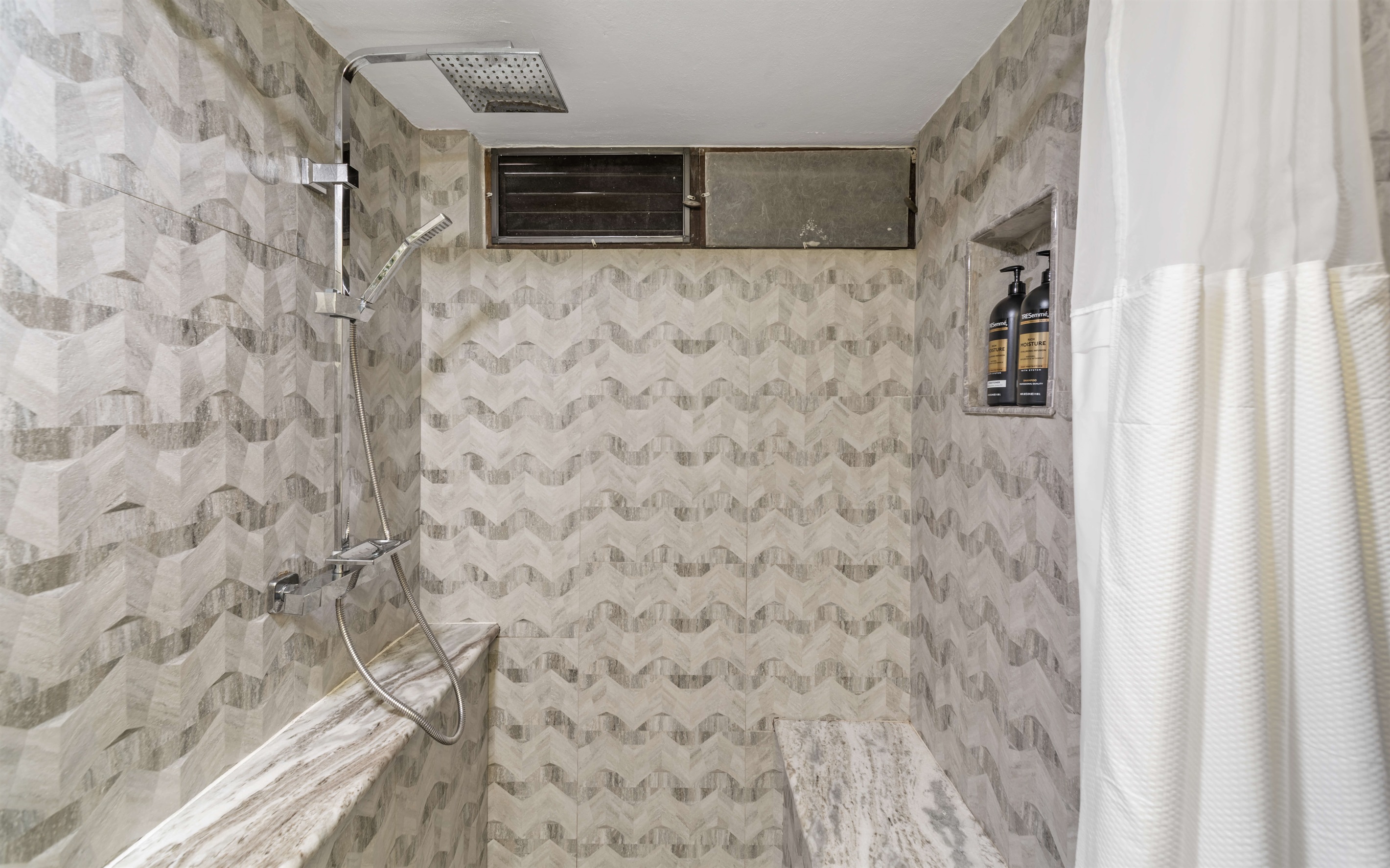 Large step in shower with shampoo & conditioner included