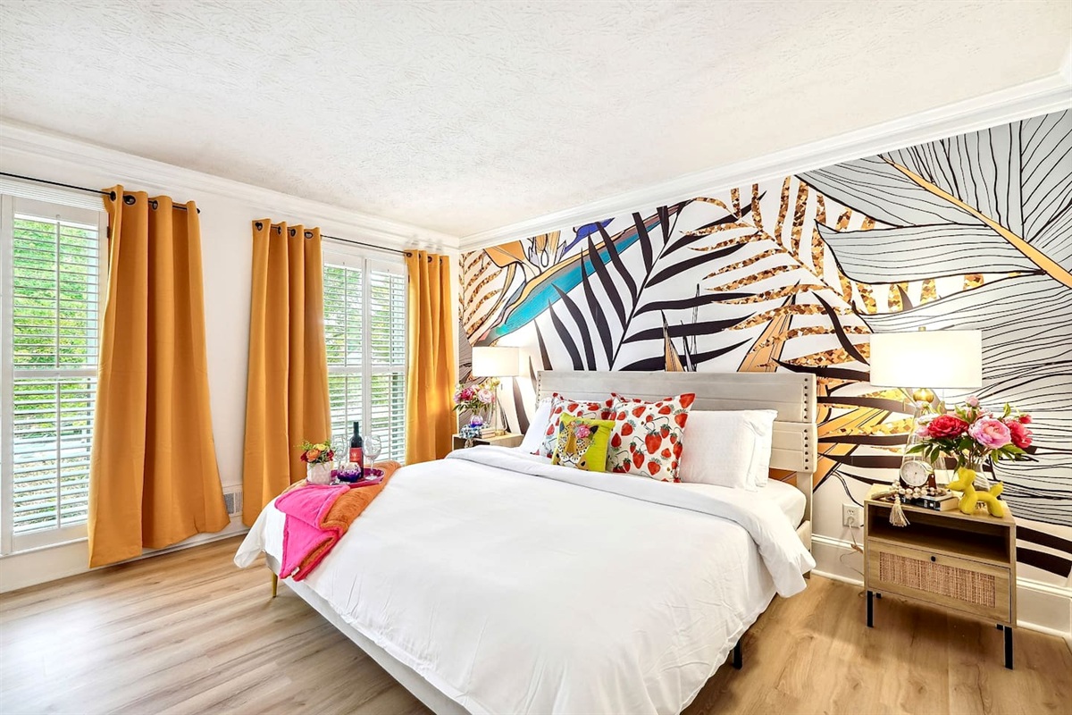 Bedroom 1 is located on the main level and features a king-size bed, TV, and a no ensuite bathroom. A nearby half bathroom is available for guest use.