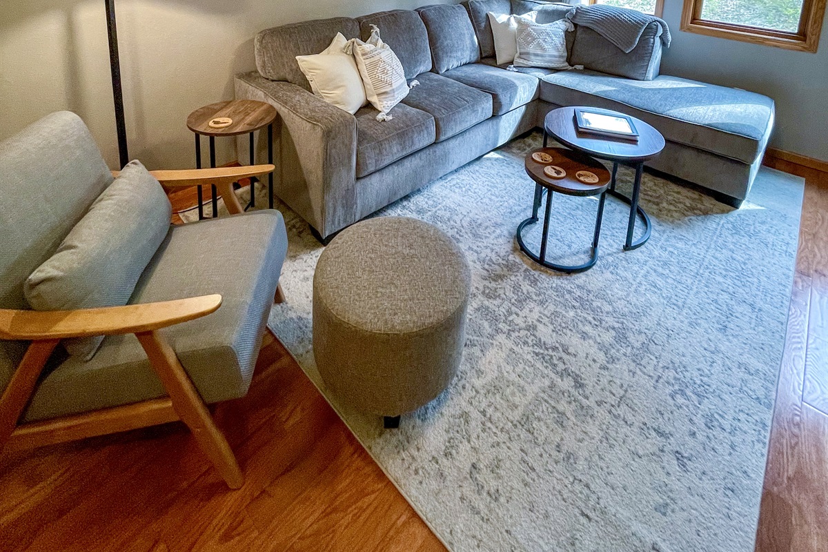 Open concept upper level kitchen living room with queen sleeper sofa memory foam. Large window and electric fireplace