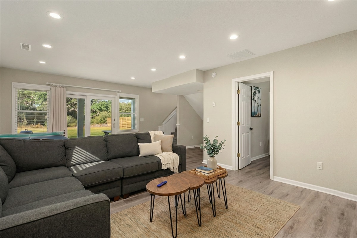 Modern entertainment area with sectional seating, great for gatherings and relaxation.