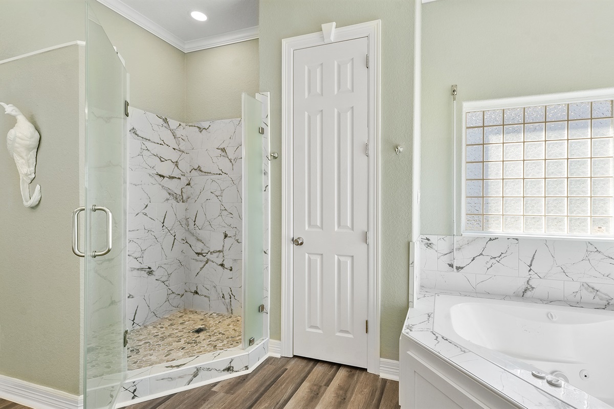 Spacious walk-in shower in the primary bathroom for a refreshing rinse after beach activities.