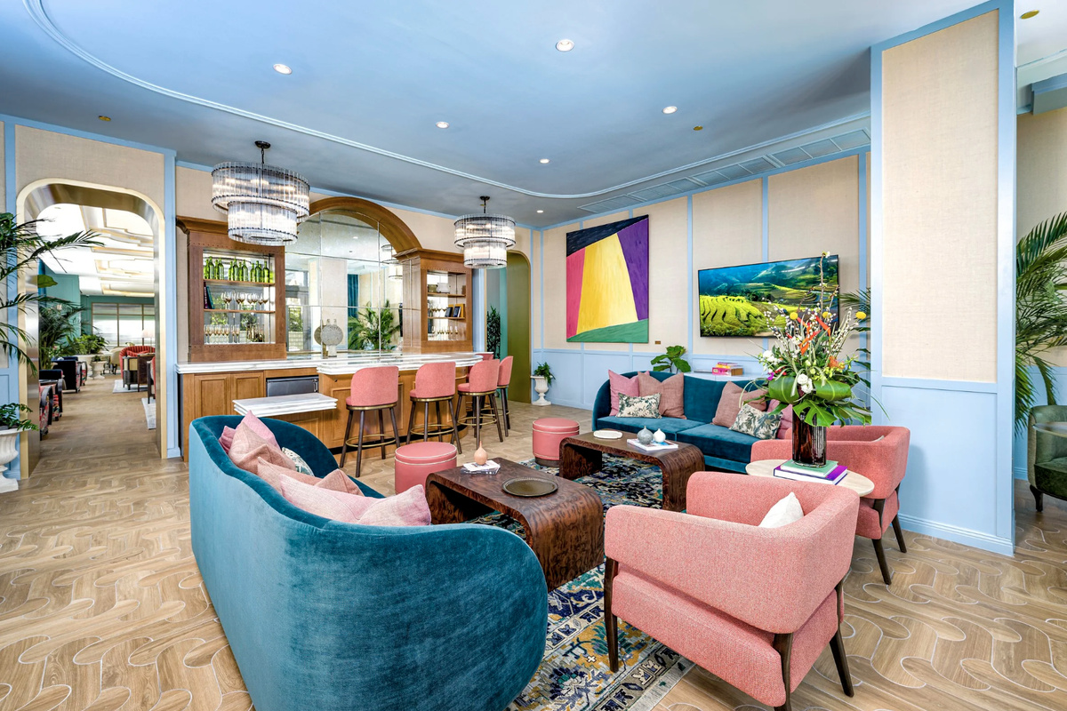 A jewel-toned social club lounge designed for gathering, with layered art, plush seating and vibrant Wynwood energy.