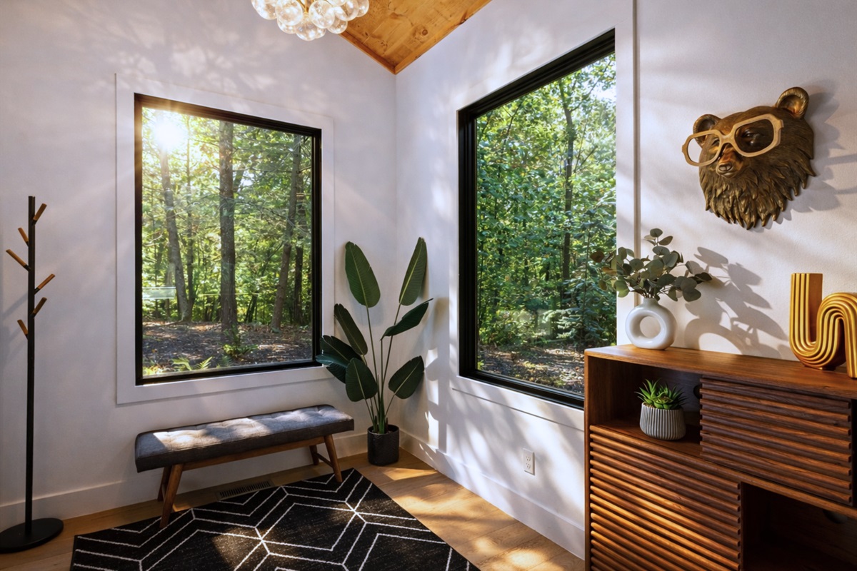 A peaceful reading nook with woodland views, earthy decor, and cozy seating for quiet moments.
