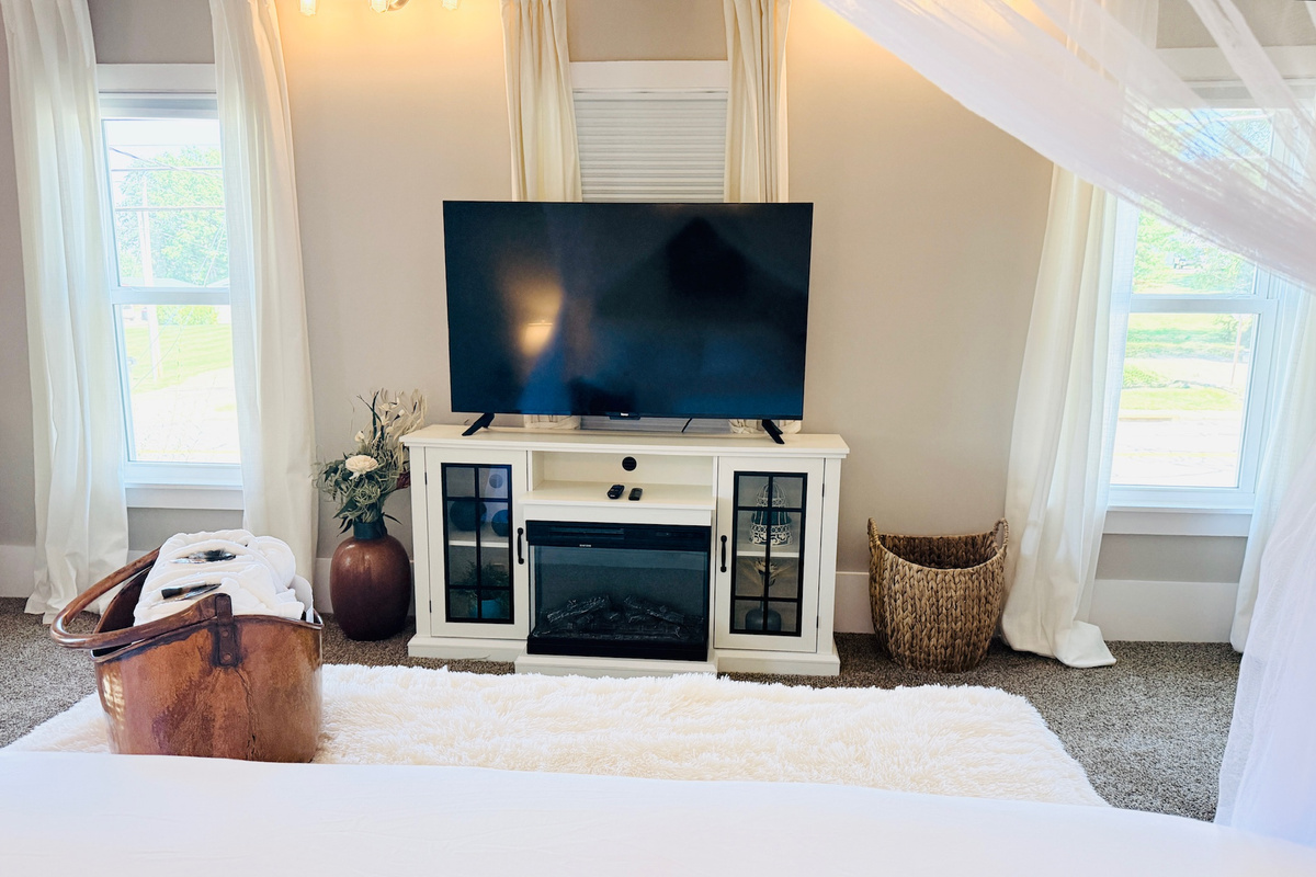 Primary suite includes a 60-inch TV and additional seating.