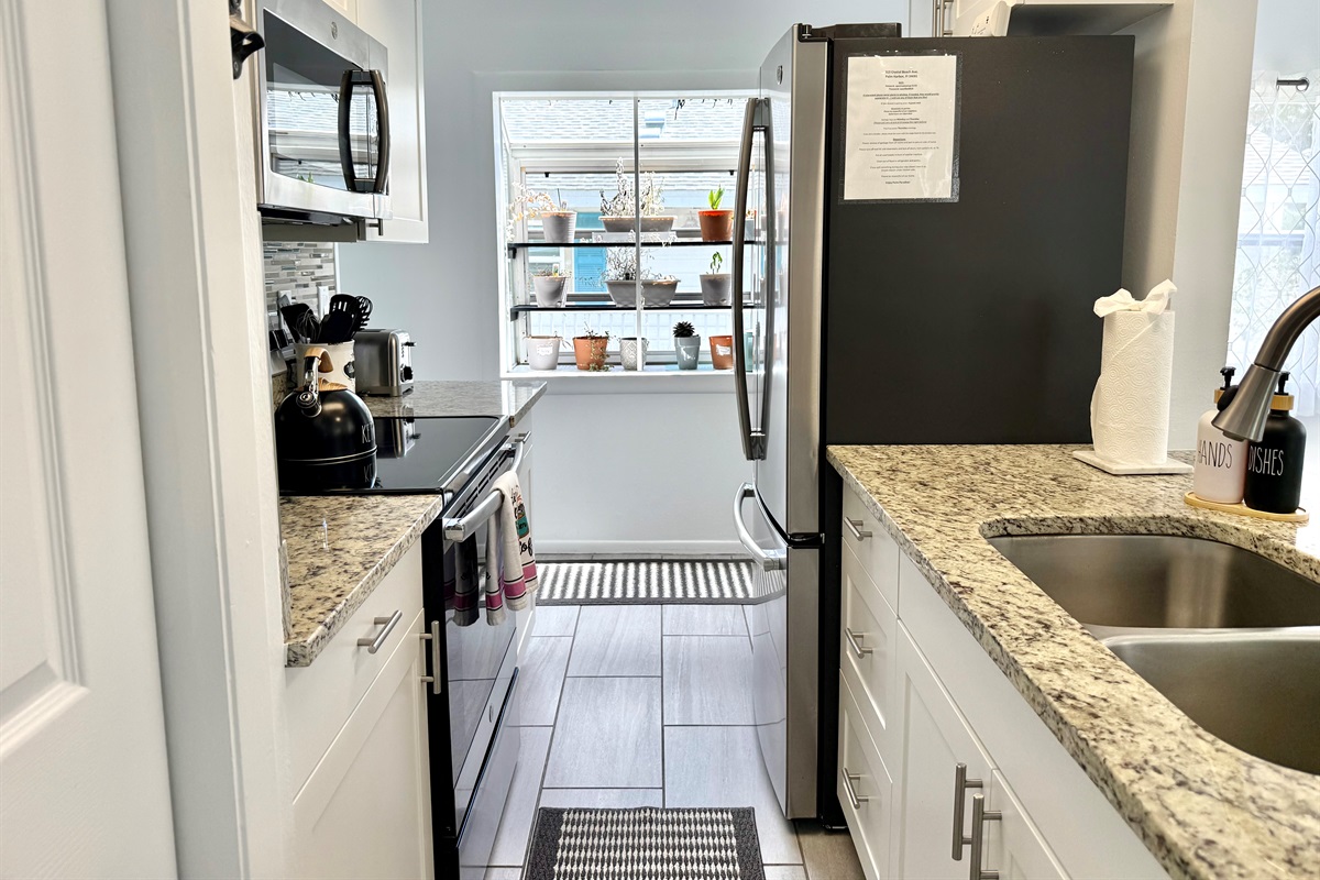 The kitchen’s open pass-through design keeps you connected with guests in the dining room while you cook.