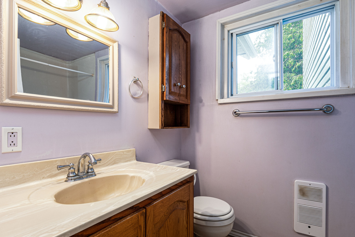 Bright bathroom vanity with mirror and storage cabinet