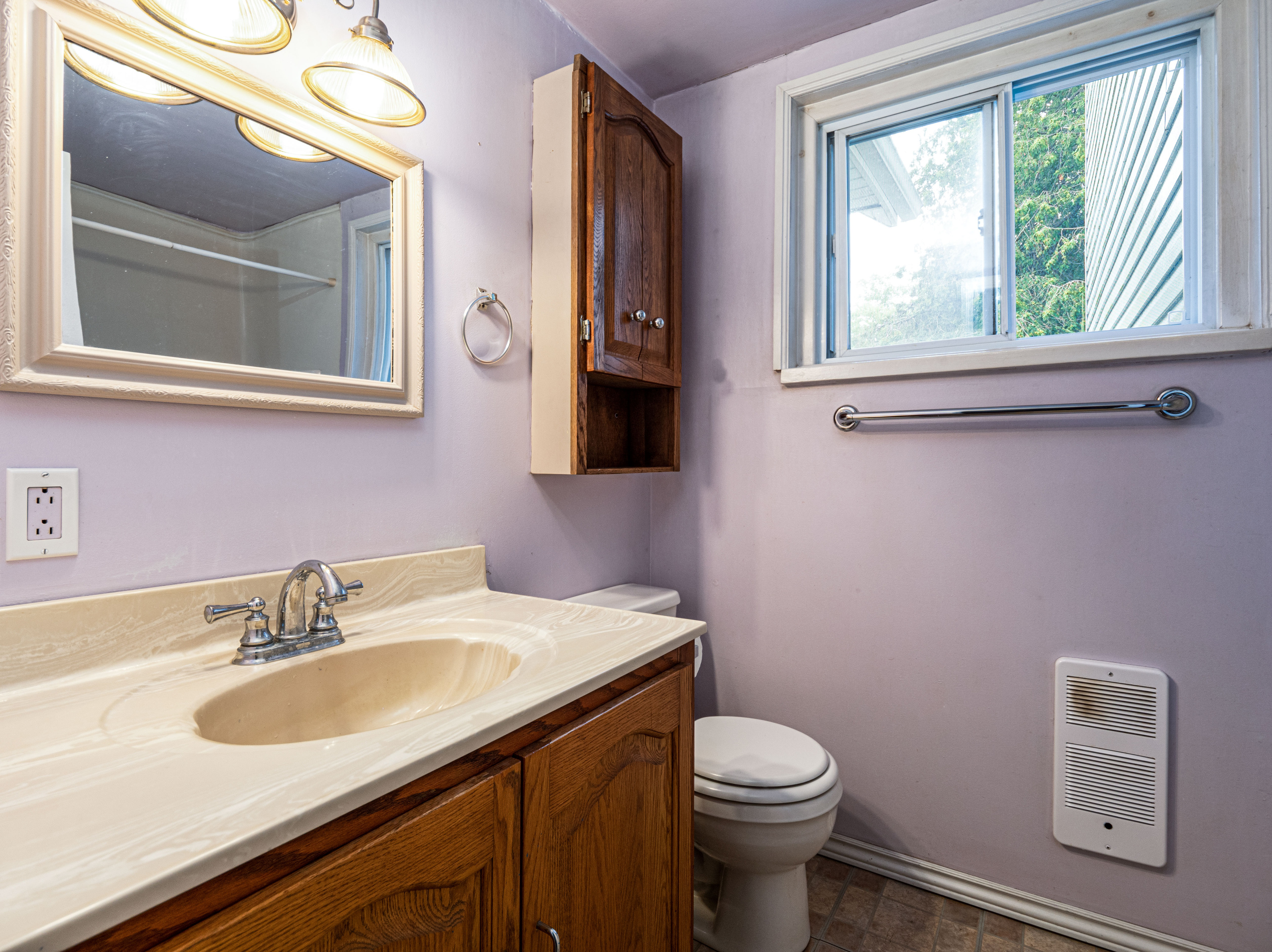 Bright bathroom vanity with mirror and storage cabinet