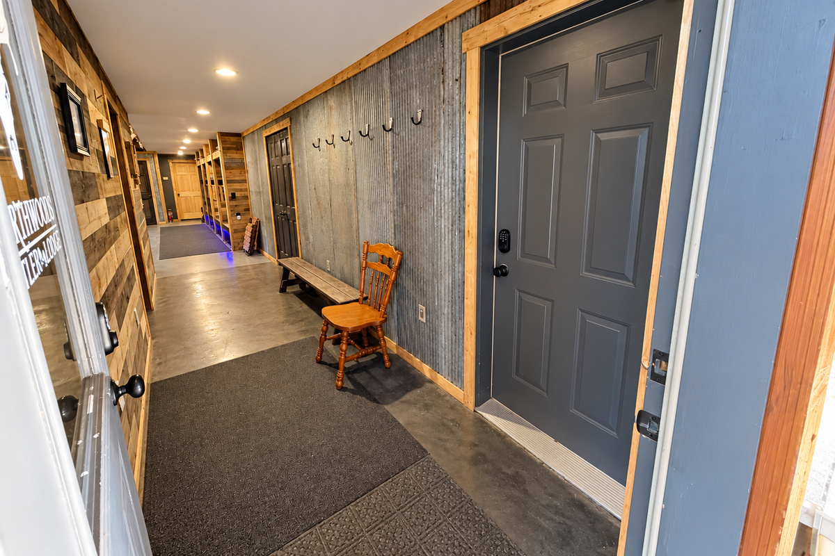 Step inside to a secure smart-lock entrance leading into the lodge living area, with a long interior hallway providing convenient access through to the attached garage.