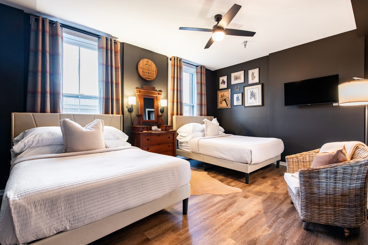The bedroom has two beds together in one room.