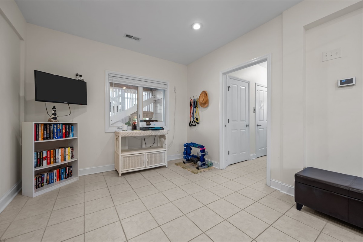 Spacious ground floor living room with TV and lounge area