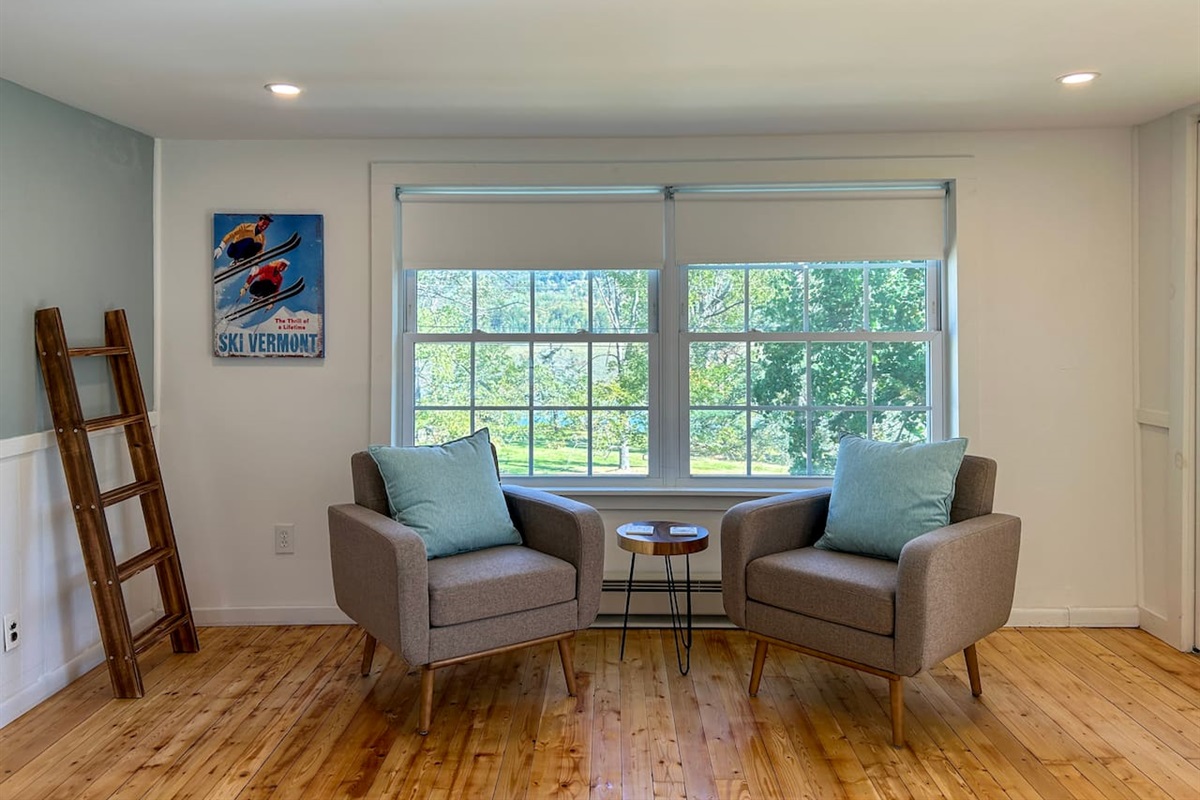The sitting area in the primary bedroom is a nice spot for a quiet moment with tea or coffee in the morning or an afternoon break with a book