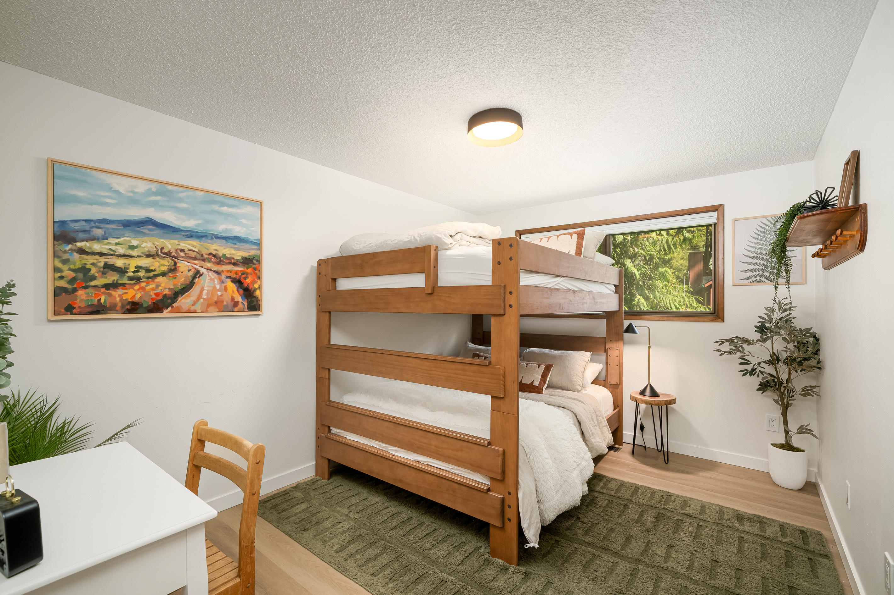 Double the sleeping space with a queen-over-queen bunk bed and a convenient desk for work or play.