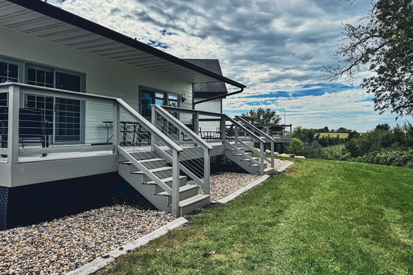Rear deck and steps overlooking the lawn and countryside.