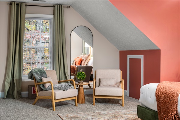 Lounge seating and soft, layered bedding make this space as stylish as it is comfortable.