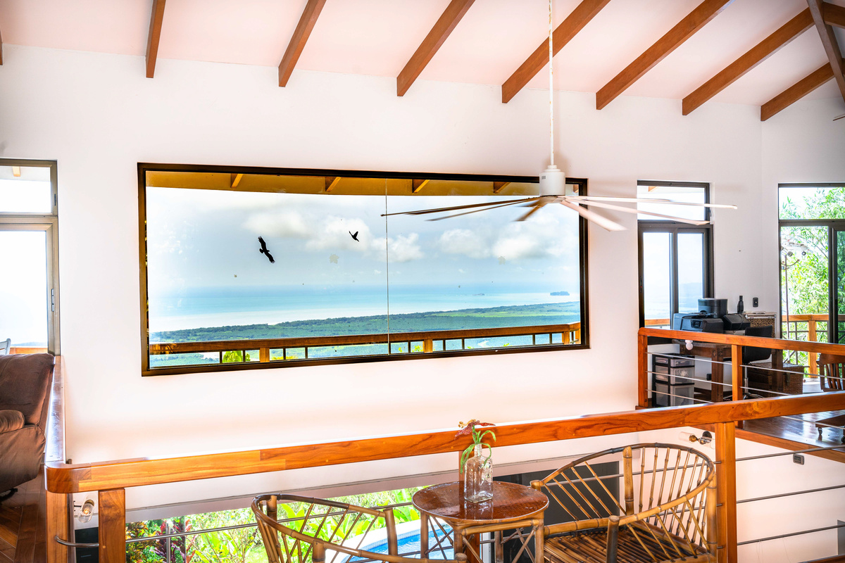 Open-plan living and dining area with panoramic ocean views — future master suite