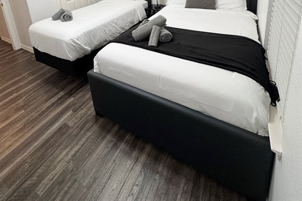 A perfect space for children or extra guests, featuring a full bed and twin bed with soft linens.