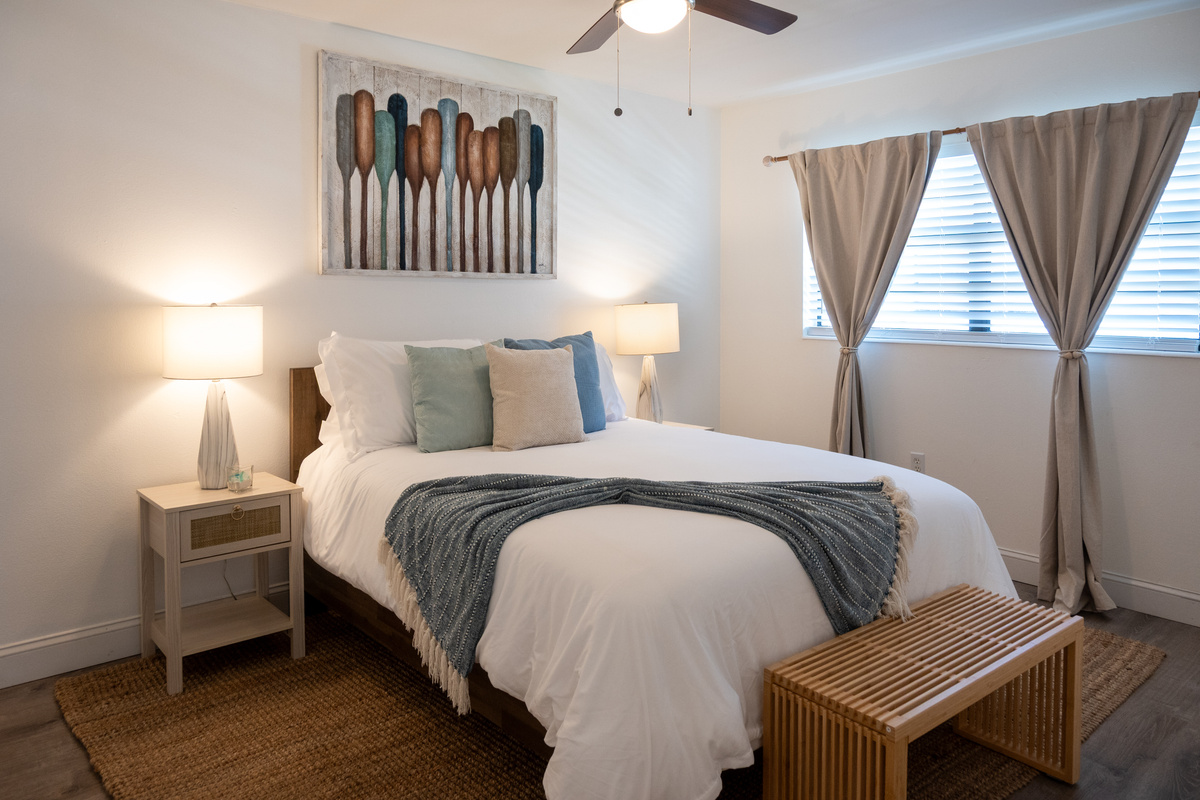 Bedroom 1 with ceiling fan and bench