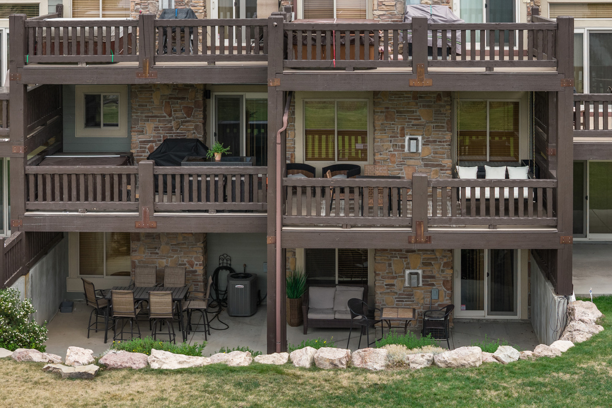 Rear view of the home highlights its spacious decks and outdoor living areas.