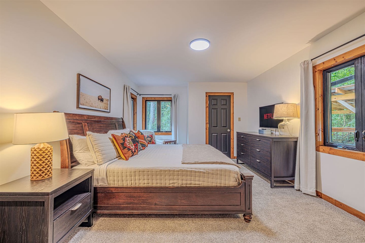 A serene king suite with a Smart TV and cozy ambiance.  Perfect for slow mornings or quiet nights in.
