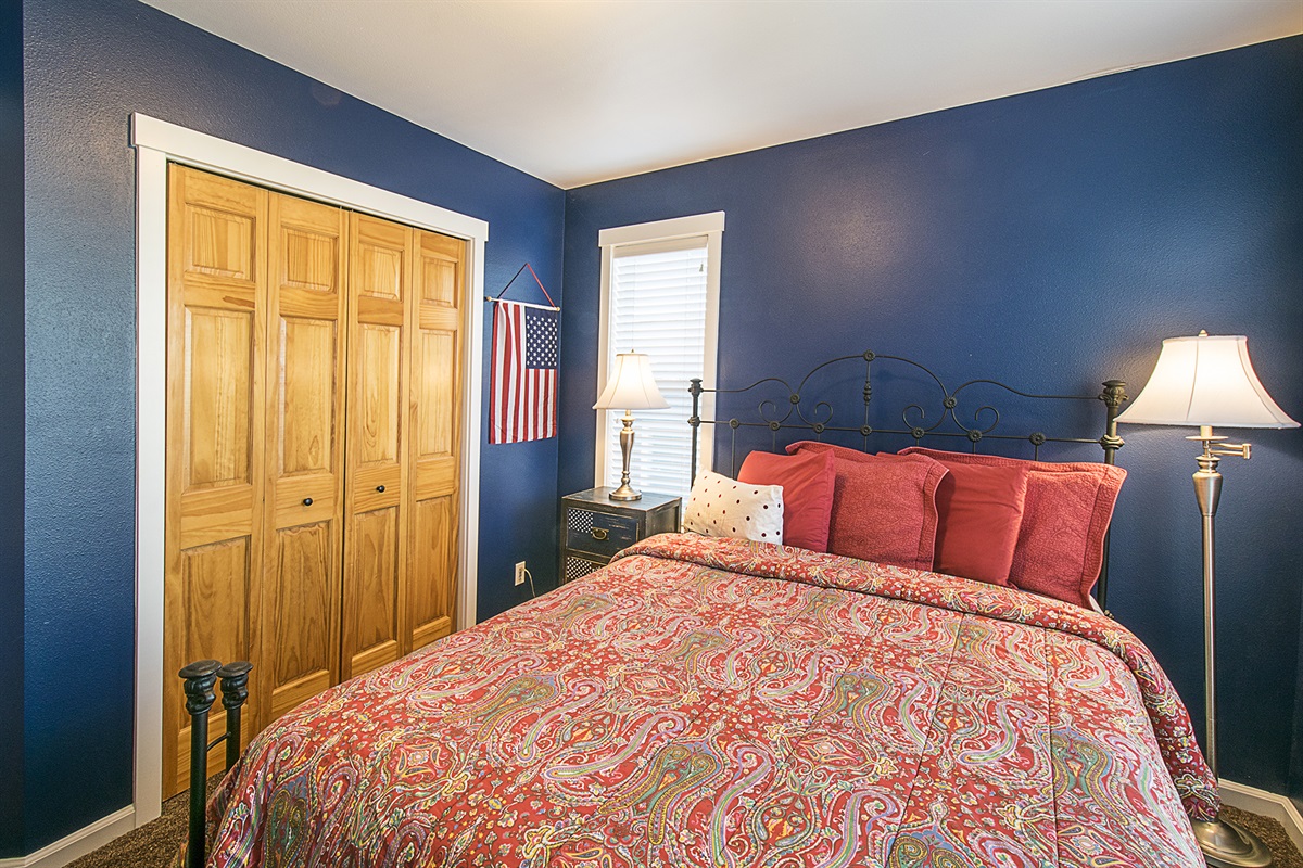 Relax in the queen room, featuring navy blue walls that capture the charm of coastal living.