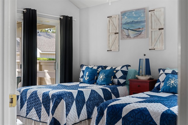 Step into a breezy coastal-inspired guest room with double beds and private patio access—perfect for kids, teens, or friends to relax and recharge after a day at the lake.