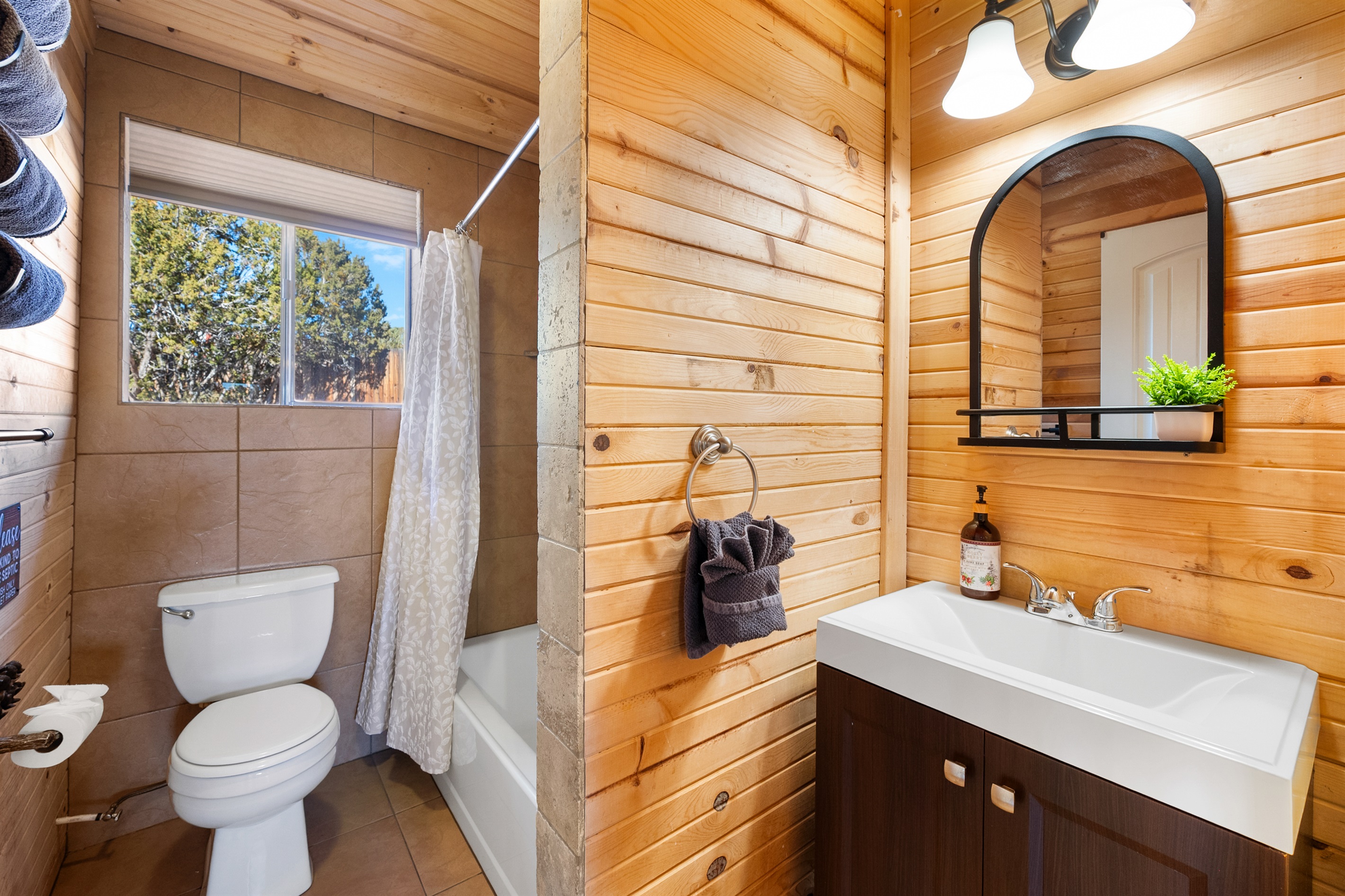 Pristine Bathroom: Refresh and unwind in the spotless bathroom, offering a bathtub, shower, and a supply of fresh towels and toiletries.