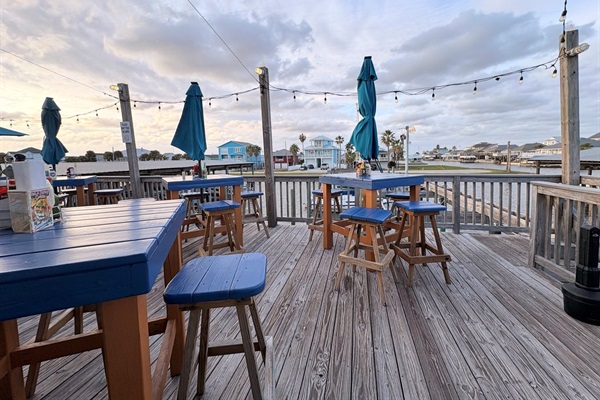 Best seating at the West End Marina Restaurant to watch the boat activity and enjoy a relaxed vibe with live music on weekends.