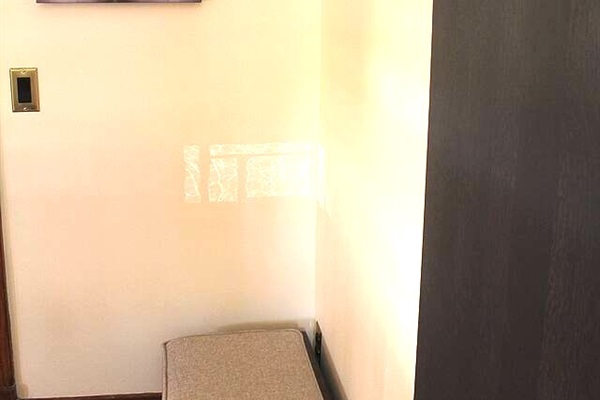 Foyer, near the dining area, provides coat hooks and bench storage