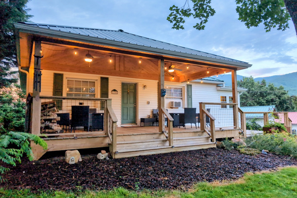 The Bailey Hot Springs — covered porch at dusk with Blue Ridge mountain views"