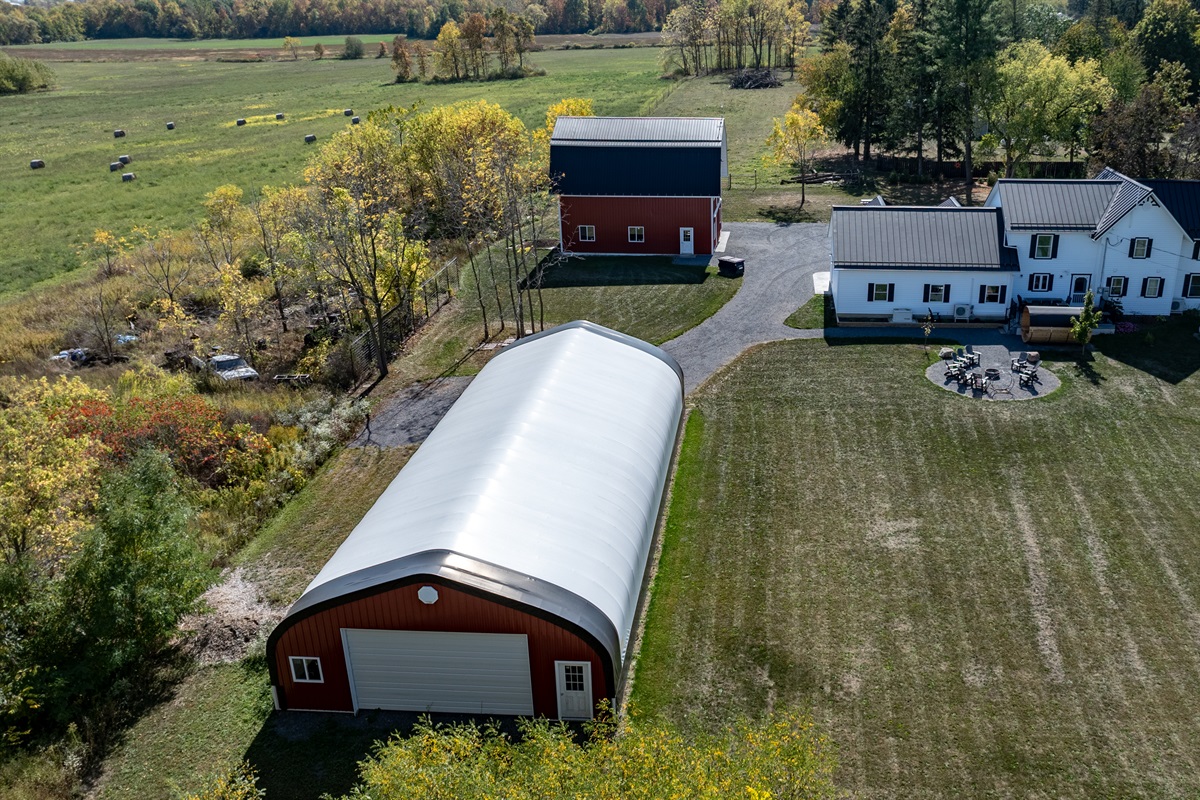 Expansive aerial view of farmhouse and barn — space, privacy, and rustic beauty in every direction