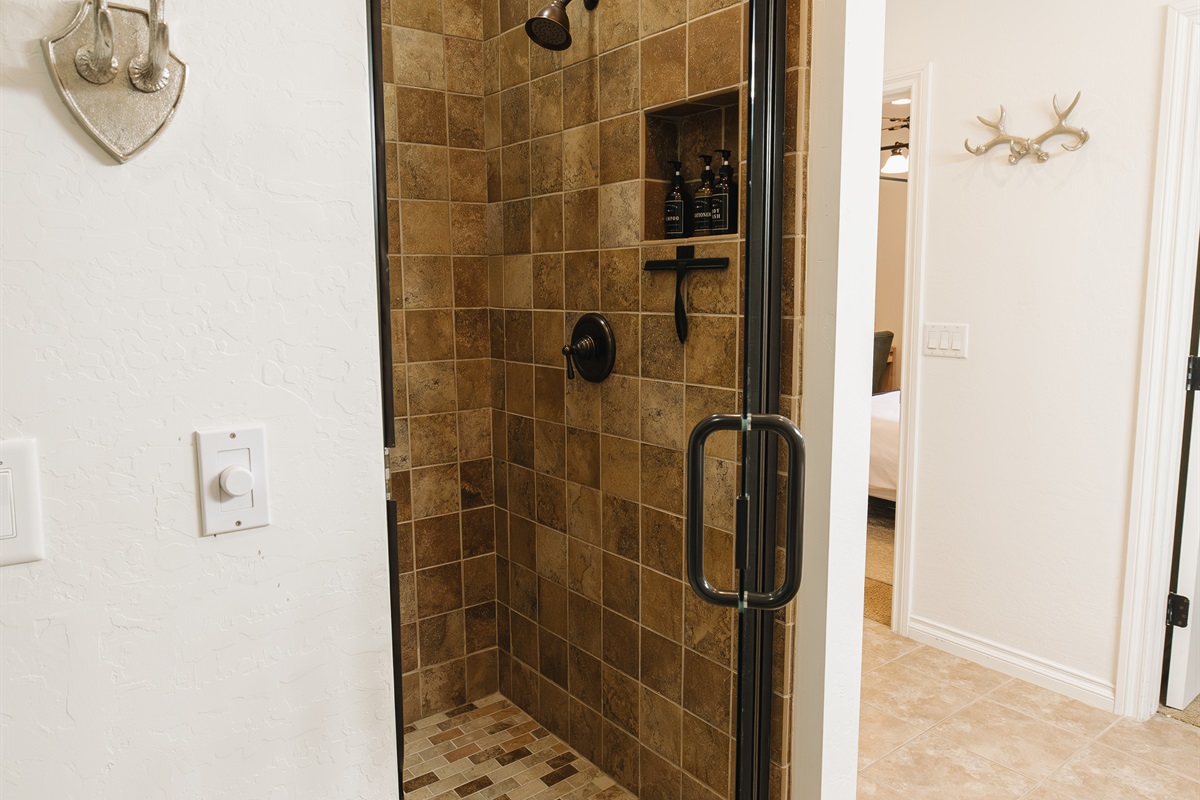 Walk-in tiled shower with glass door, rainfall-style showerhead, and spa-inspired finishes—perfect for refreshing after a day of lake time, hiking, or skiing in the White Mountains.