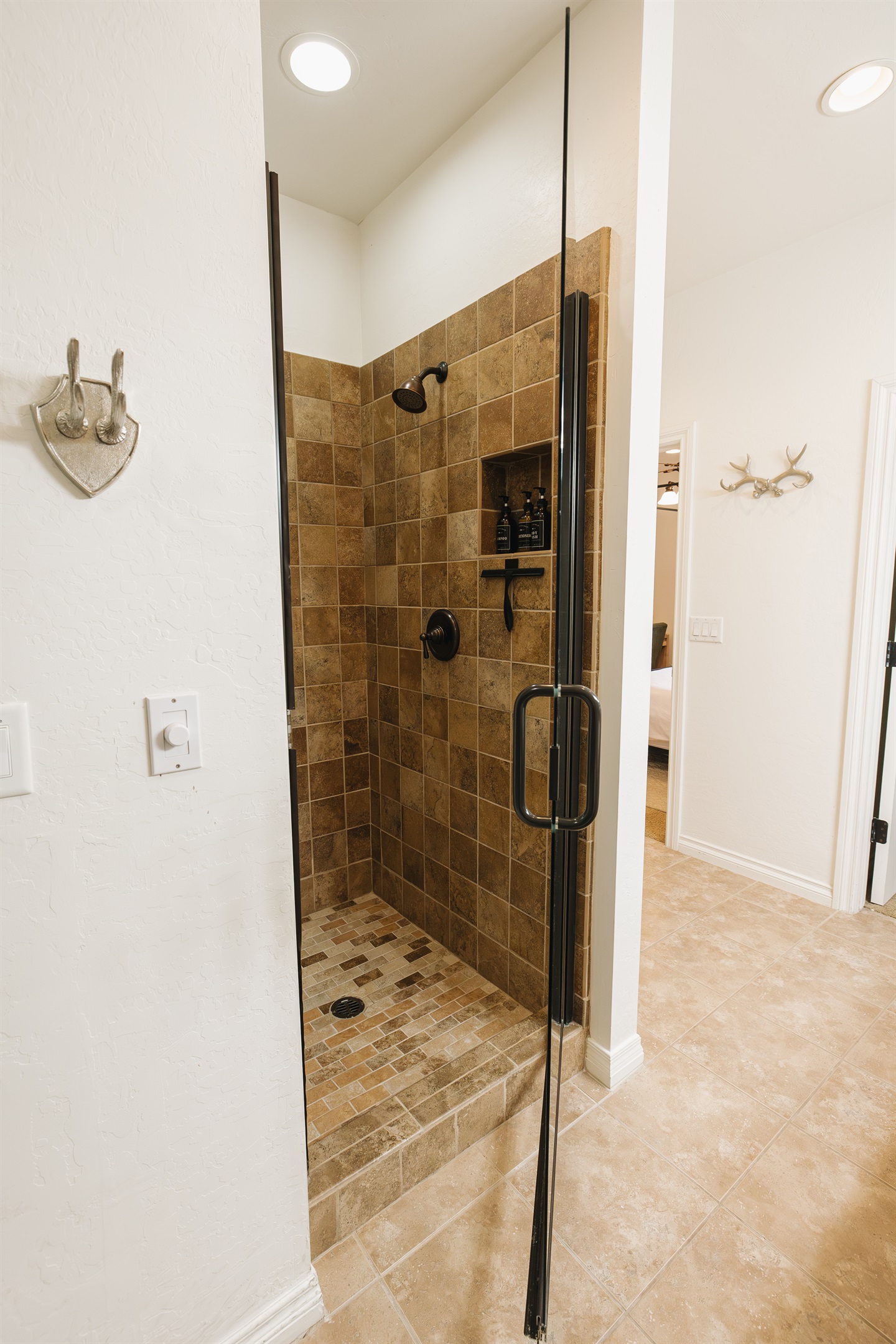 Walk-in tiled shower with glass door, rainfall-style showerhead, and spa-inspired finishes—perfect for refreshing after a day of lake time, hiking, or skiing in the White Mountains.