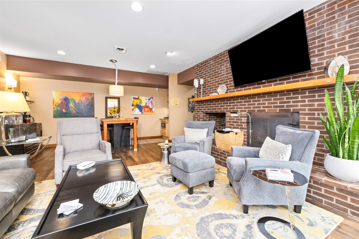 If the Koi were watching from the pond, this is what they would see! 65" Roku, lots of spots to lounge and catch up or winter binge watch together. And, watch the Koi right back!