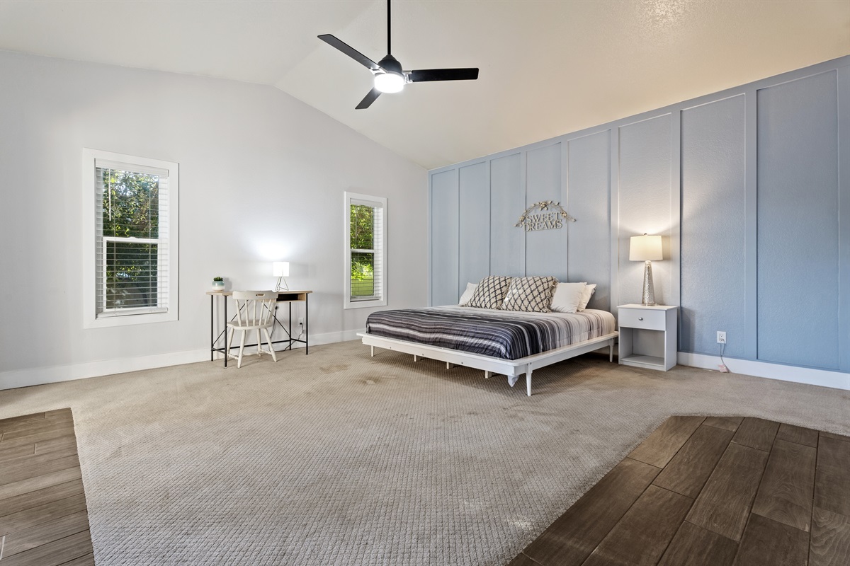 Unwind in the spacious primary bedroom with a king bed, dedicated workspace, and extra room for a Pack ‘n Play or lounge area.