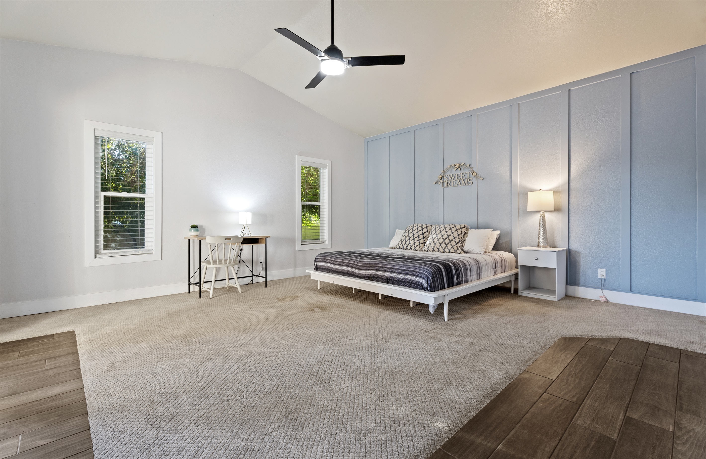 Unwind in the spacious primary bedroom with a king bed, dedicated workspace, and extra room for a Pack ‘n Play or lounge area.