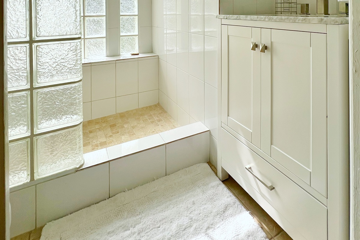 Wall-mounted mirrors and chest drawers add style and practicality.