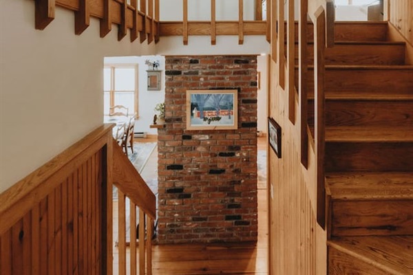 View from the front door with a short staircase going down to the main level and up to the upper level