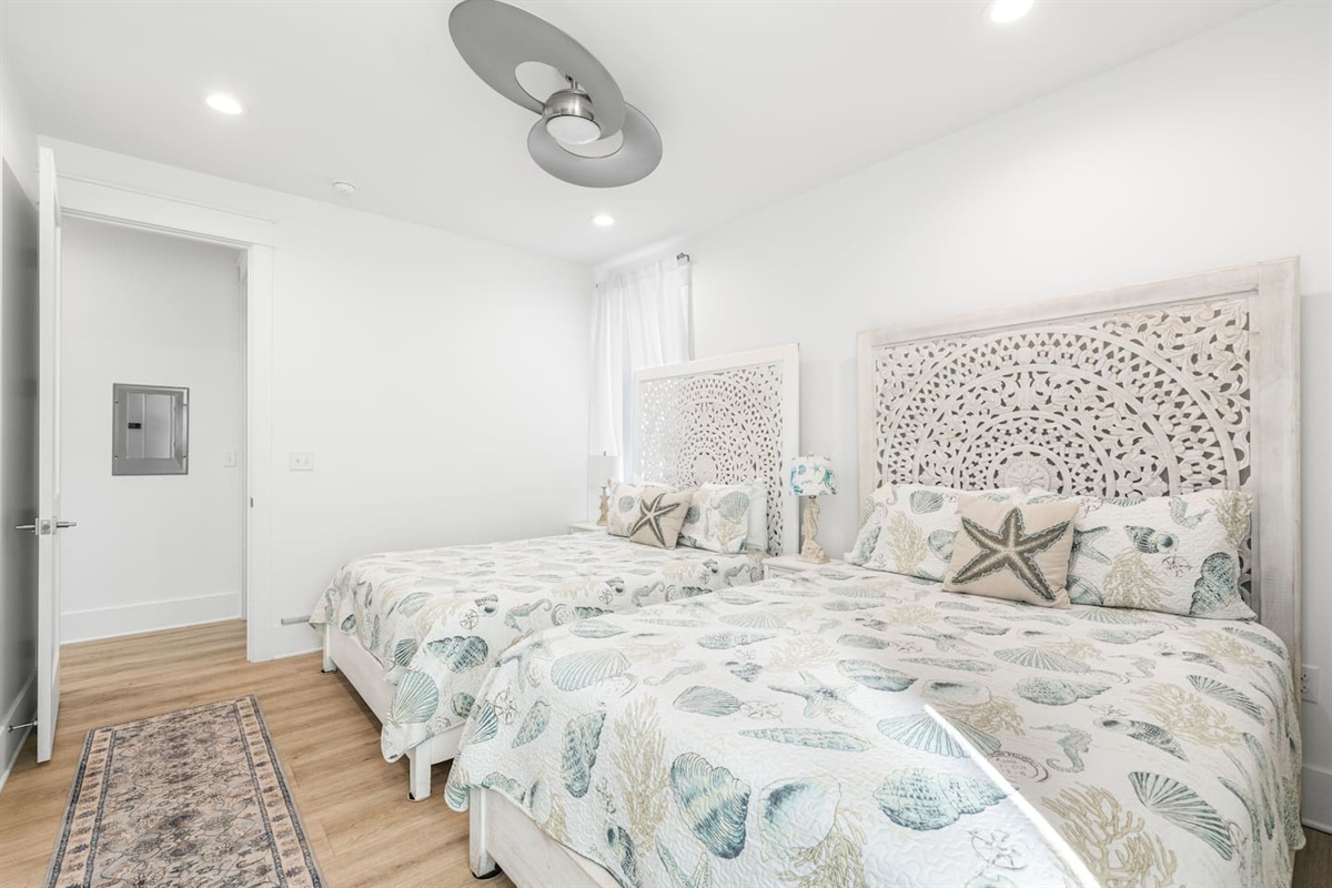 Experience 30A luxury in this serene guest suite featuring two unique Balinese-carved Queen beds.  Catch your favorite shows on the Smart TV and stay cool with the high end customer set AC and Supersonic fan. In Room Closet  Also:  adjoining bathroom 