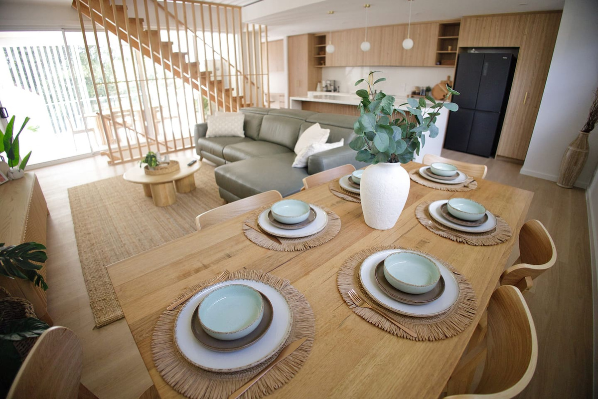 one of 2 dining tables, with the full kitchen and living room in the background