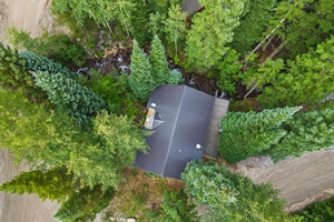 Aerial Serenity: Gazing Down on a Cozy Cabin Nestled Amidst Nature's Beauty. 🌲🏡🌞 #CabinRetreat