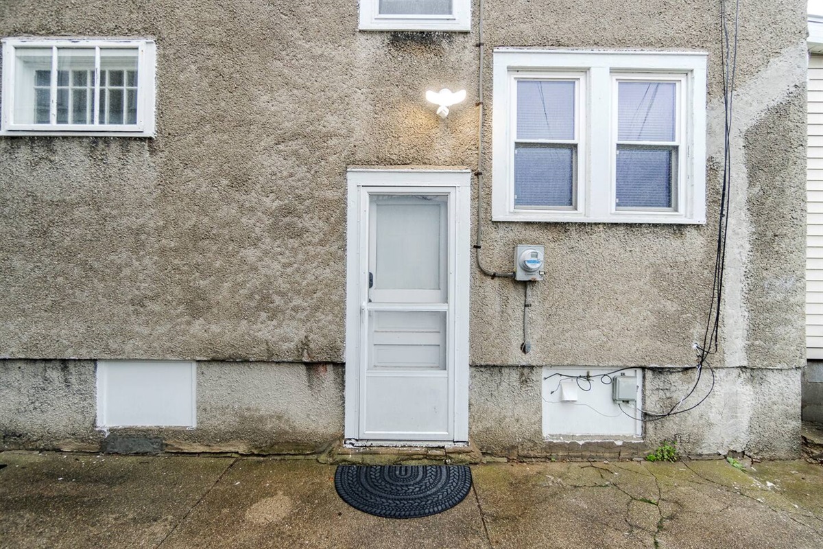 Charming exterior view featuring the entrance door of the house, offering a warm and inviting first impression—highlighting modern design elements and a welcoming atmosphere for guests and residents alike.