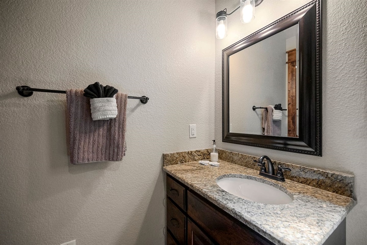 The second full bathroom is ensuite of the upstairs bedroom with a king size bed