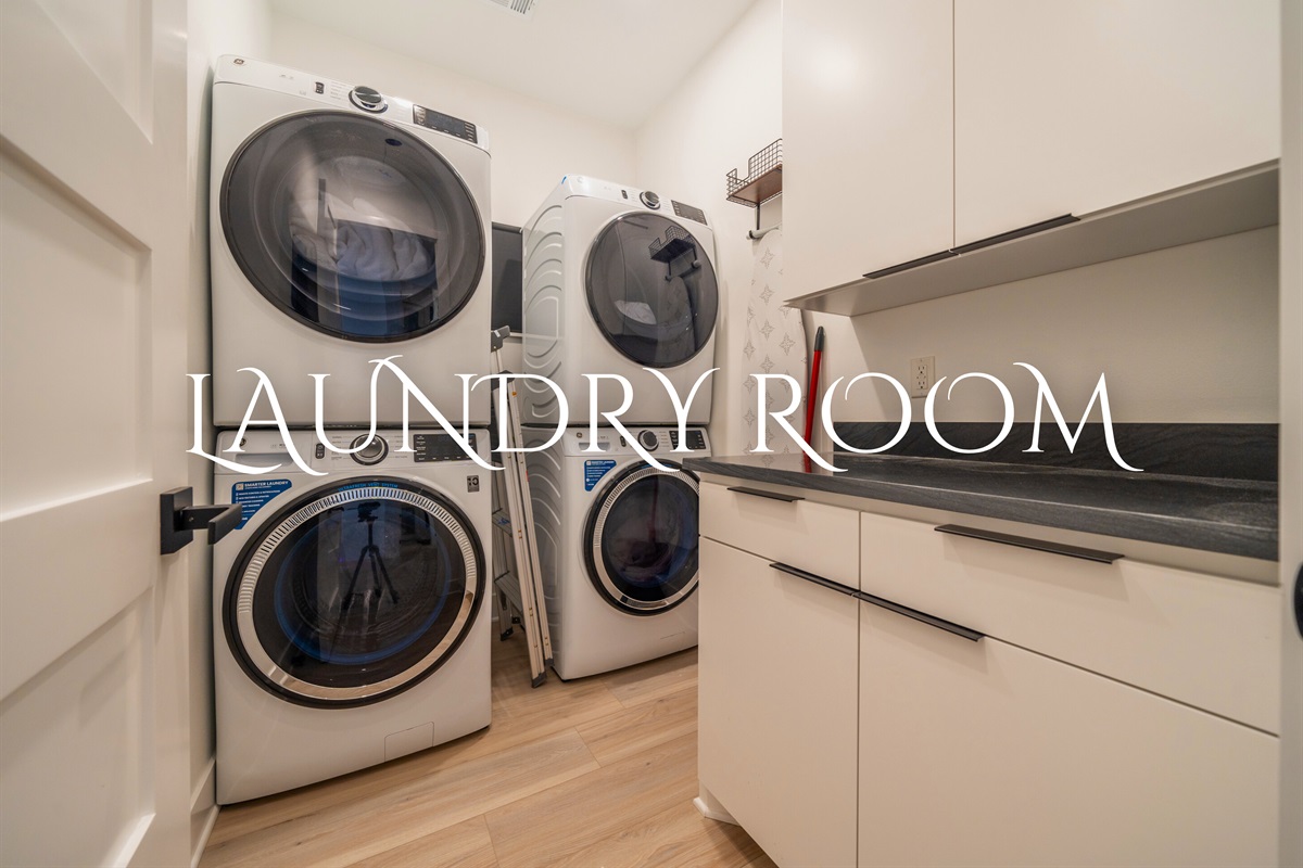 This sleek and efficient laundry room features state-of-the-art appliances to make laundry day a breeze.