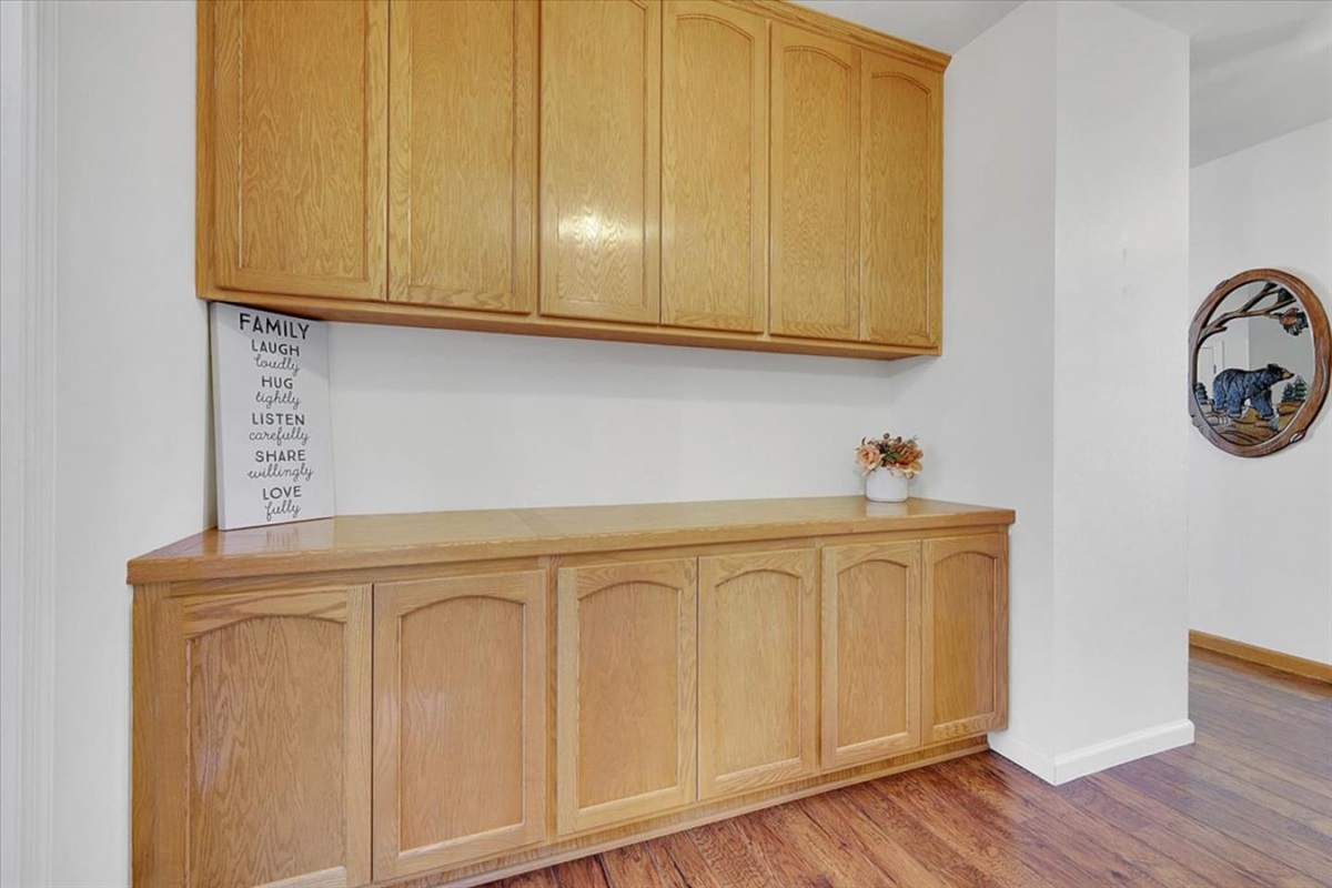 Hallway cabinet storage with wood doors and extra space to keep items tucked away.
